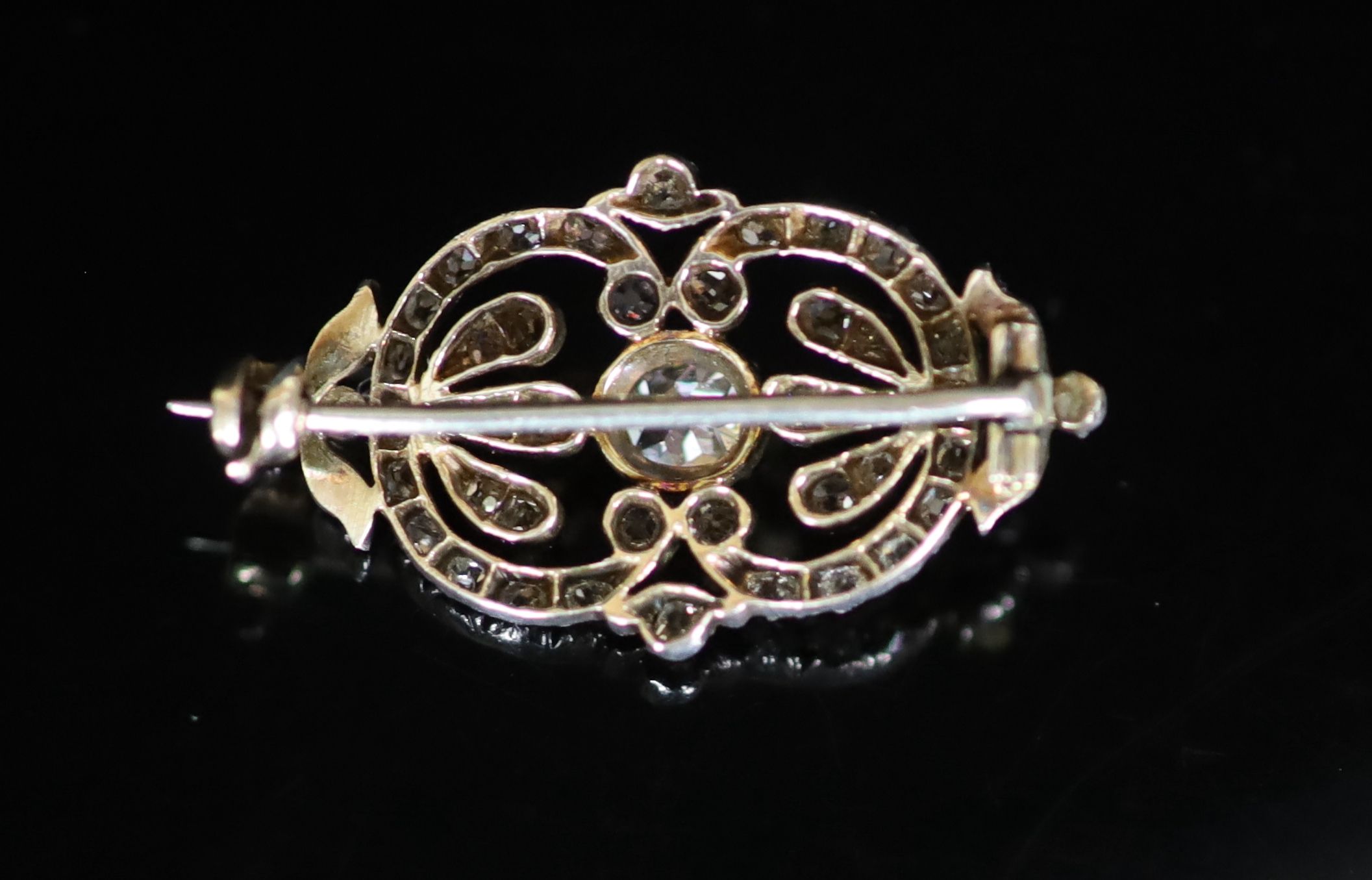 An Edwardian gold, silver and diamond set openwork oval brooch